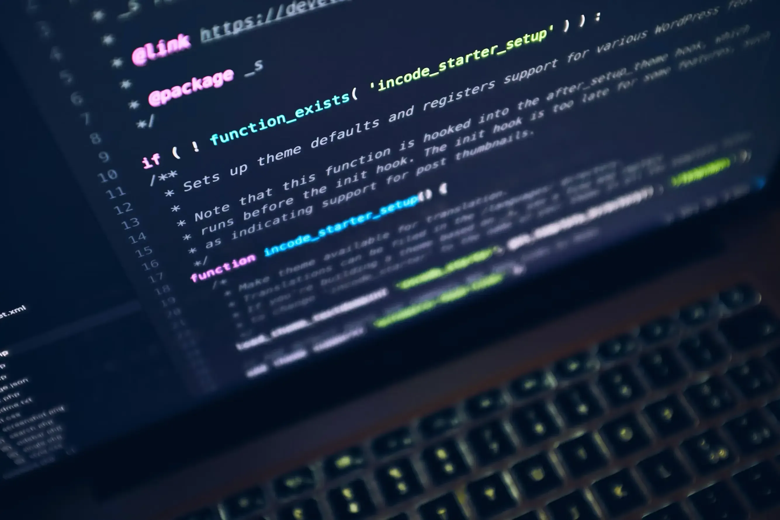 Lines of computer code are displayed on a laptop screen, showing software development.
