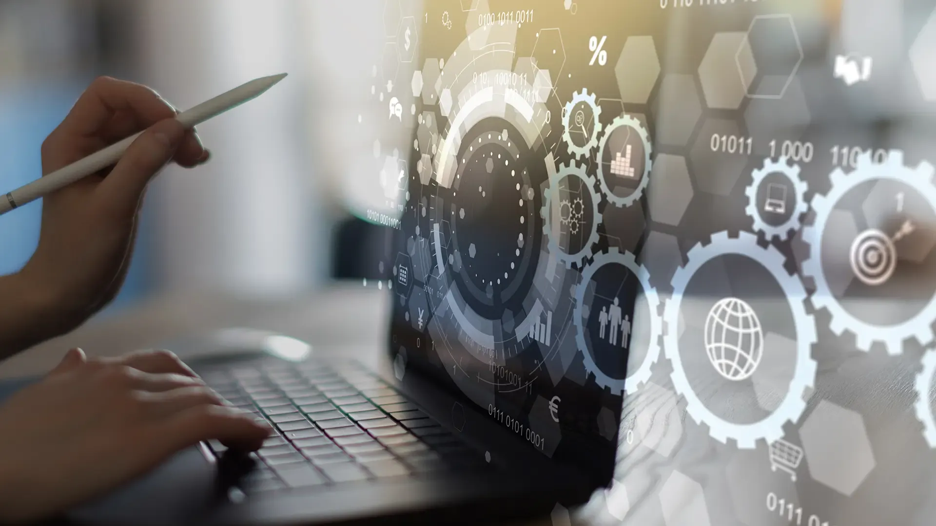Person uses laptop with a digital overlay showing gears, data, and technological concepts.