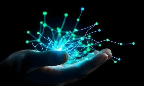 A hand holds a glowing blue-green digital network of interconnected dots and lines.