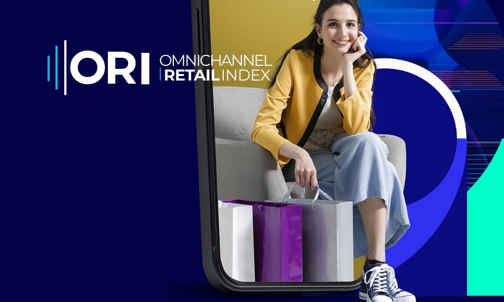 Smiling woman with shopping bags framed by a smartphone, promoting Omnichannel Retail Index.