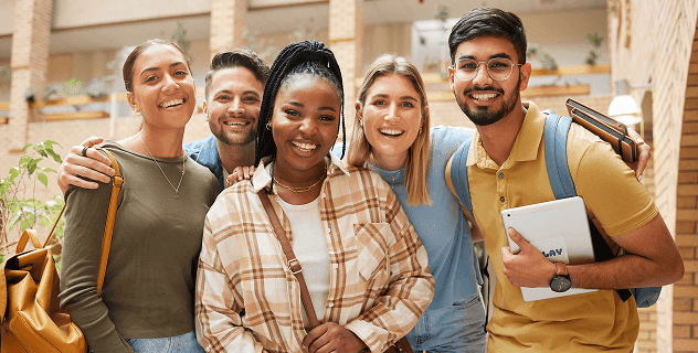 Diverse group of smiling business professionals posing together in a modern office setting.